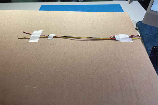 This image is of the lights running along the top of the box and into the small holes to connect to the lights.